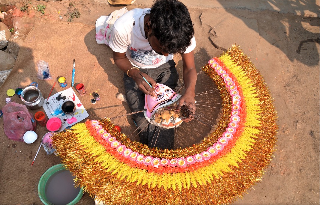 Layered pigment and paper grain on a handcrafted Maskriti mask